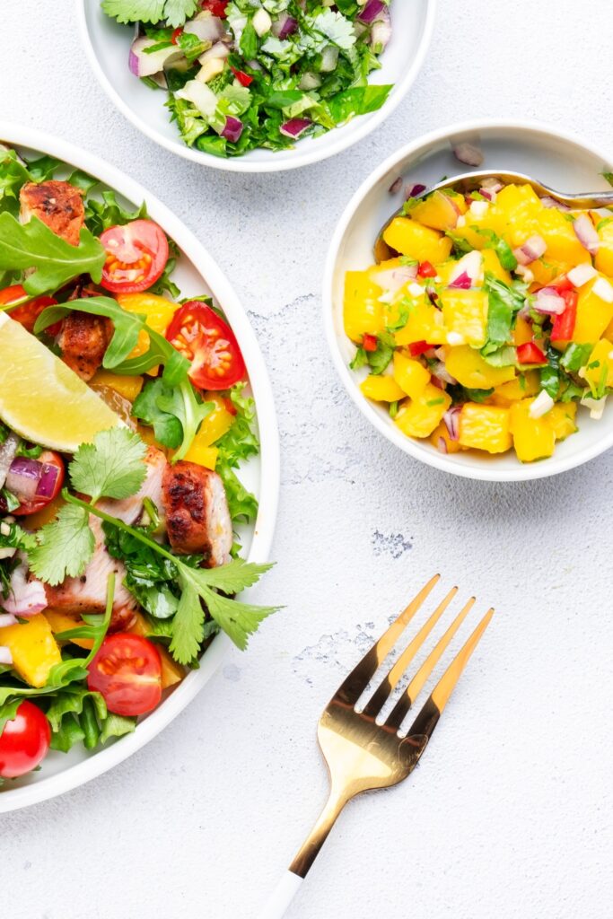 Image of mango salsa chicken made in a crockpot perfect for summer