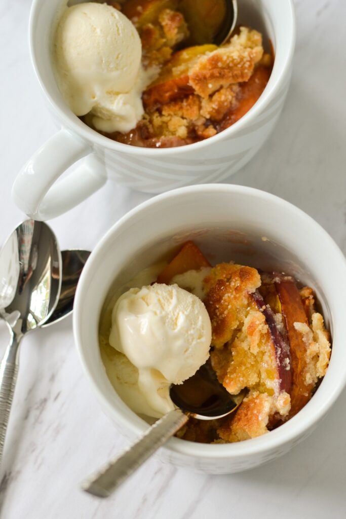 Image of peach cobbler made in a crockpot perfect for summer